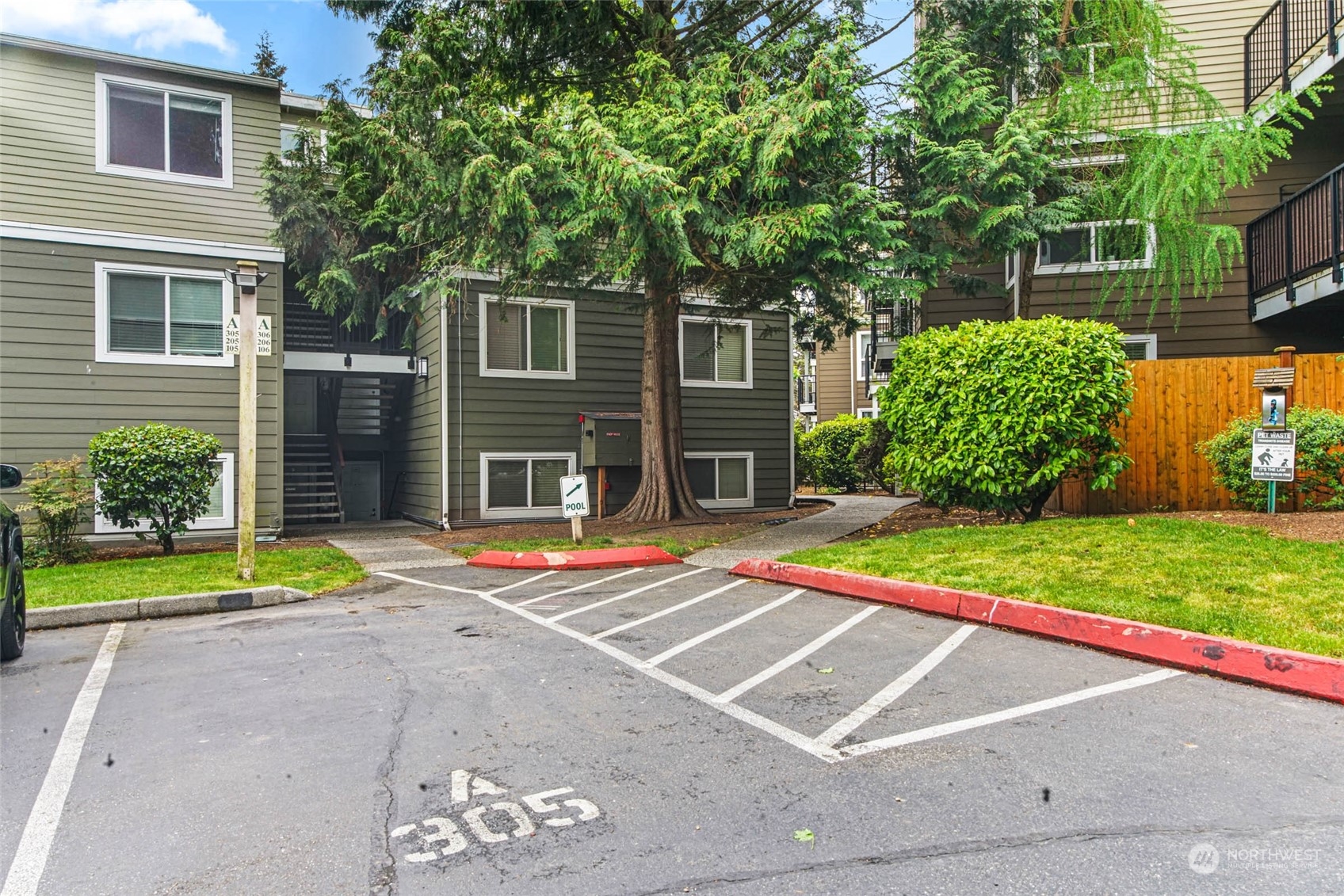 820 Cady Road, Unit A305 Everett, WA 98203 - Photo 19 of 26 a view of a backyard with table and chairs under an umbrella