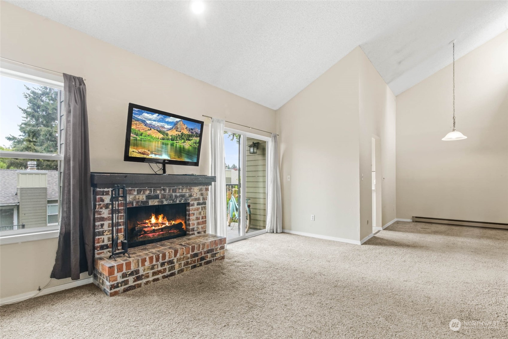 820 Cady Road, Unit A305 Everett, WA 98203 - Photo 3 of 26 a living room with furniture a fireplace and a flat screen tv