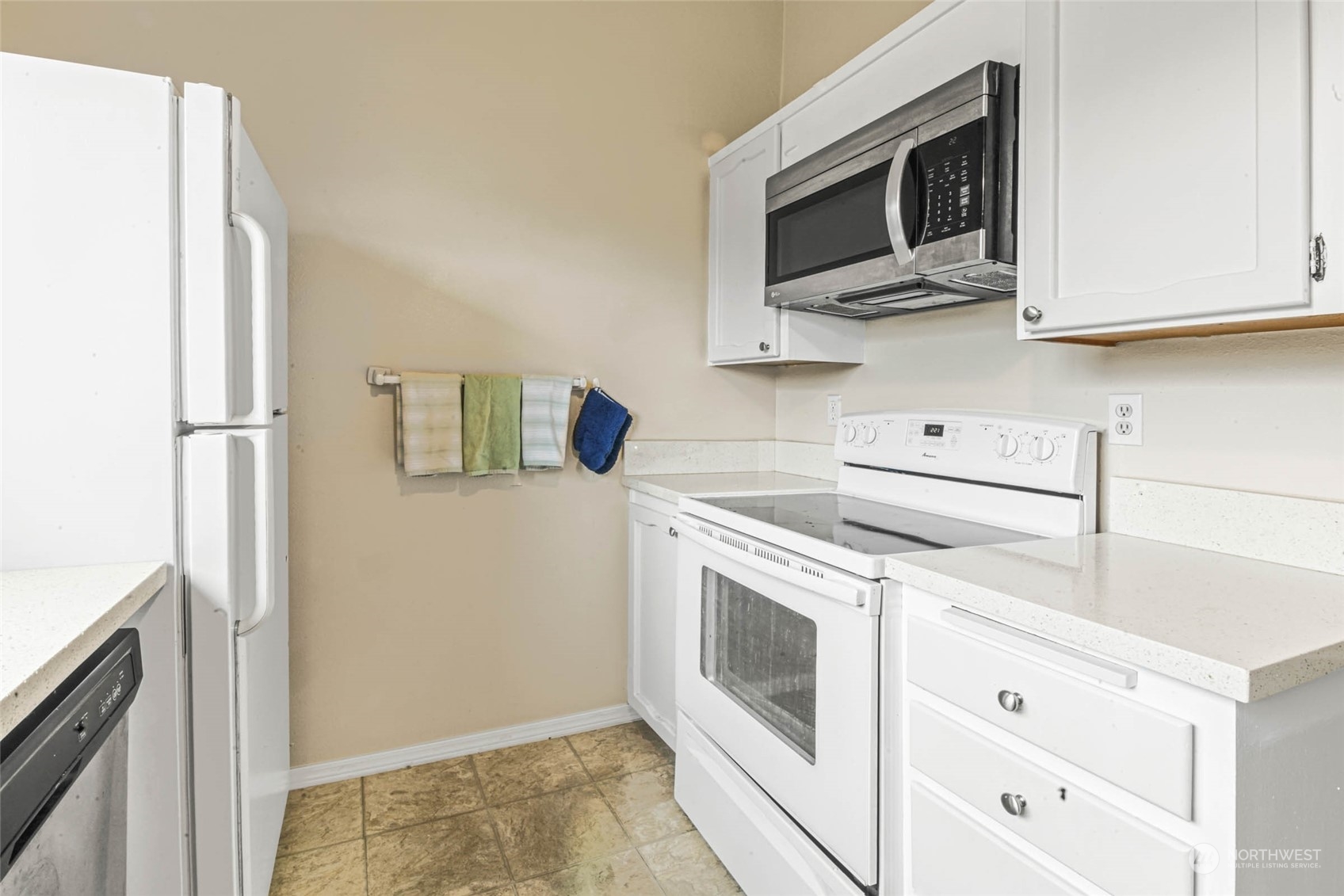 820 Cady Road, Unit A305 Everett, WA 98203 - Photo 5 of 26 a kitchen with stainless steel appliances white cabinets and a refrigerator