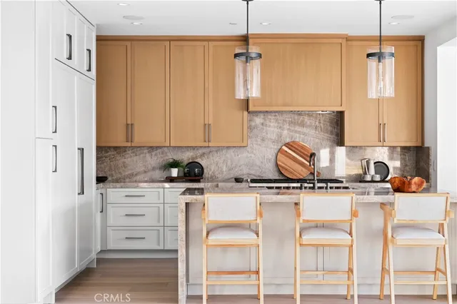 a white kitchen with a table and chairs