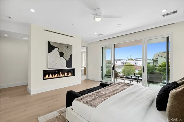 a balcony with couple of chairs and potted plants
