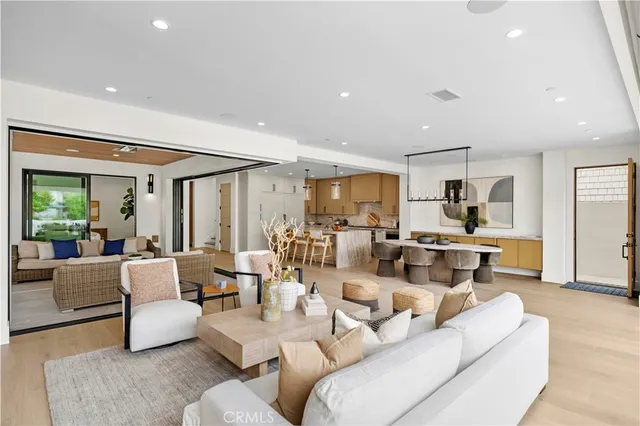 a kitchen with stainless steel appliances granite countertop a stove top oven a refrigerator a sink and white cabinets