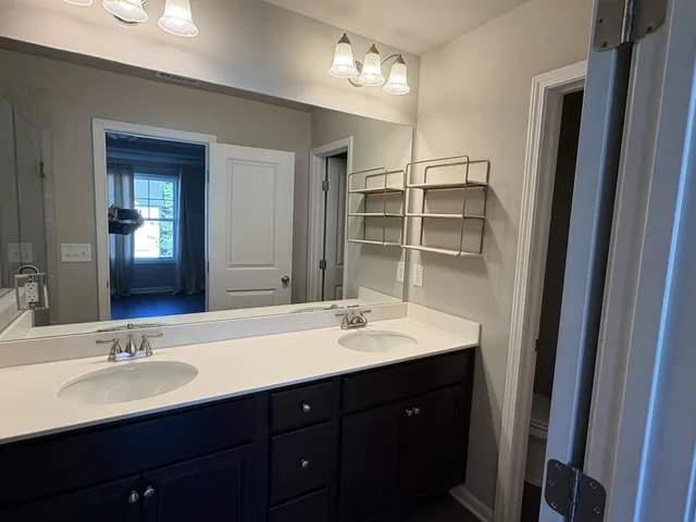 a bathroom with a double vanity sink and a mirror