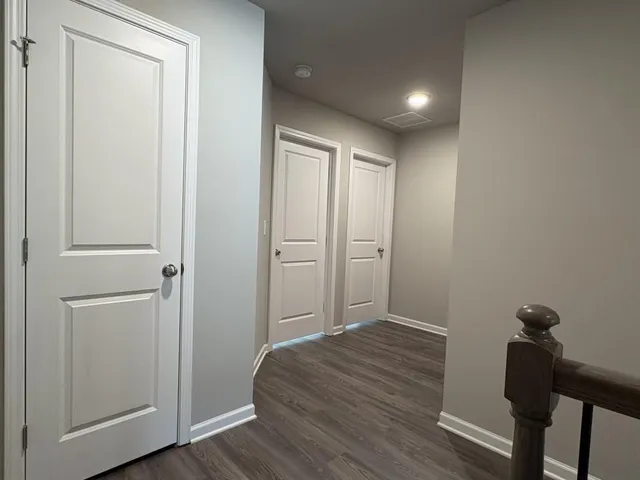 a view of room with wooden floor