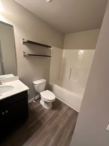 a bathroom with a sink a toilet a shower and a mirror