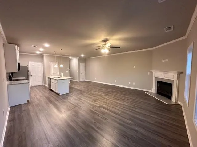 a view of a kitchen with a sink and a fireplace