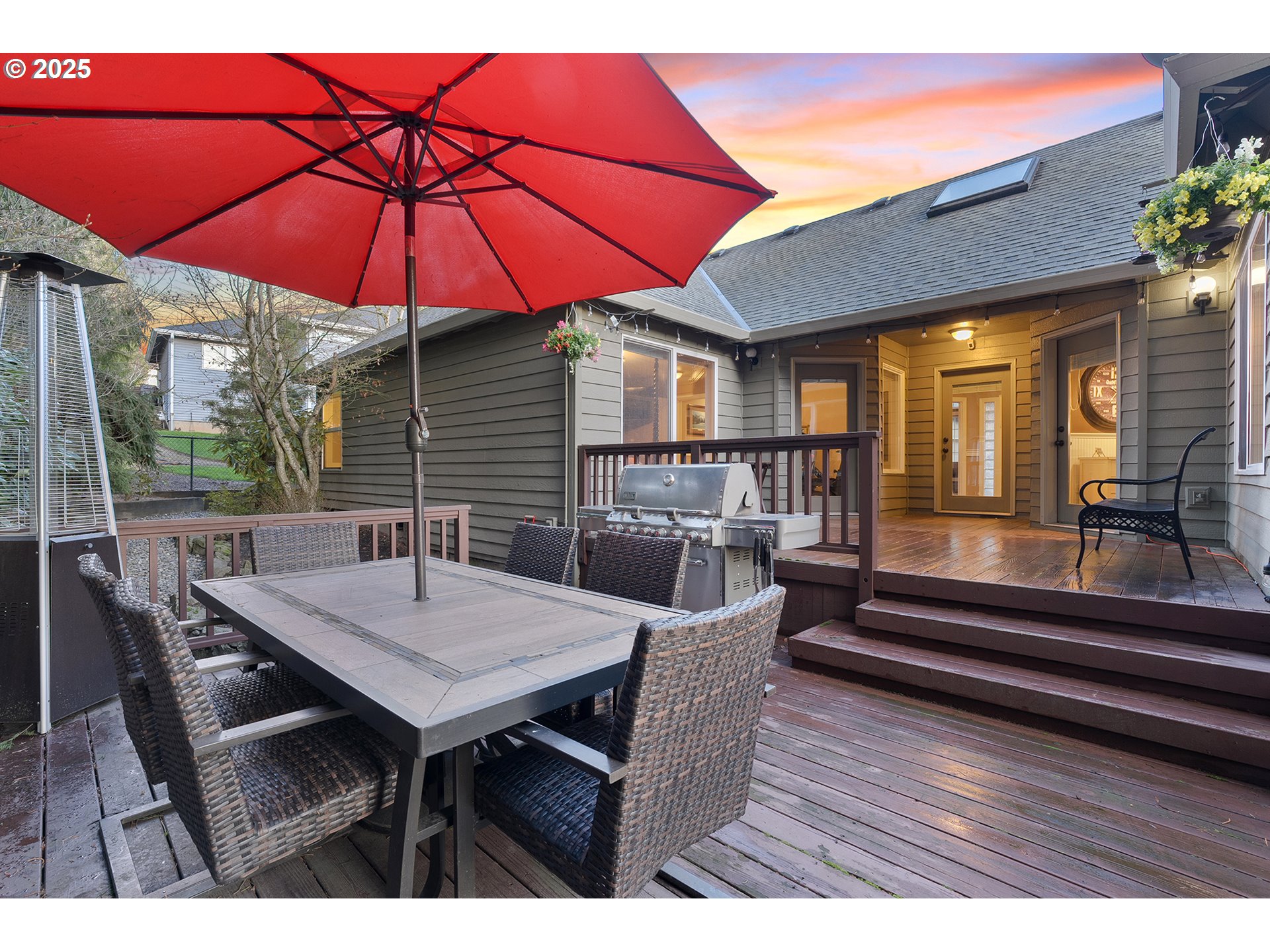 15943 Southwest Enna Court Portland, OR 97224 - Photo 40 of 48 a view of a patio with table and chairs under an umbrella