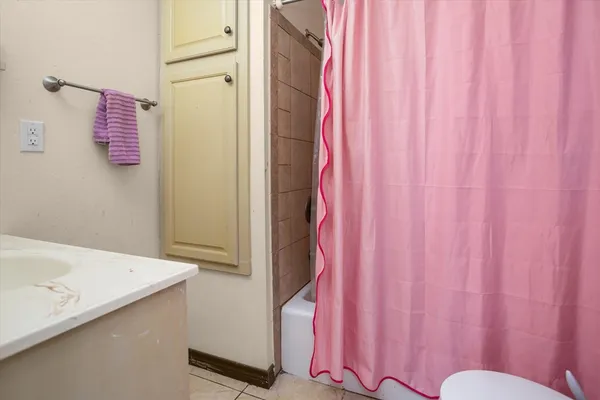 a bathroom with a shower curtain and a curtain