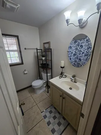 a bathroom with a sink a toilet and mirror