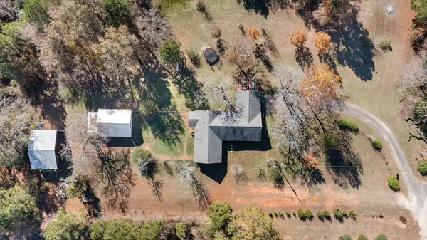 an aerial view of a house with a yard