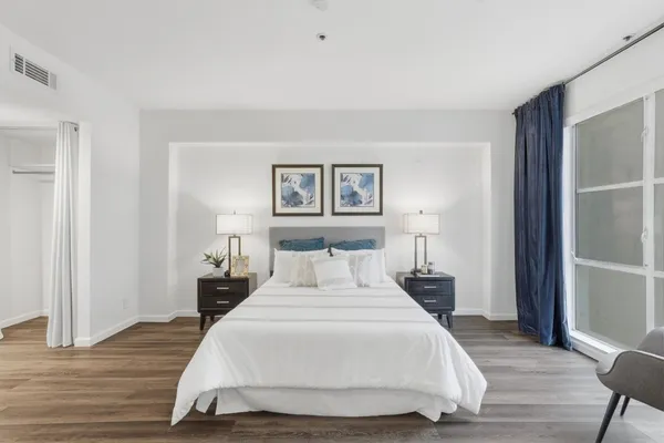 a bedroom with a bed and a night stand