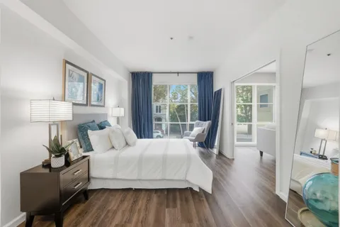 a bedroom with a bed and wooden floor