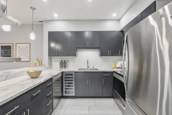 a kitchen with a sink stainless steel appliances and cabinets