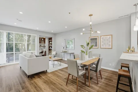 a living room with furniture and a wooden floor