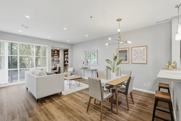 a living room with furniture and a wooden floor