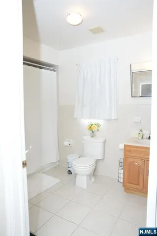 a bathroom with a toilet a sink and a shower