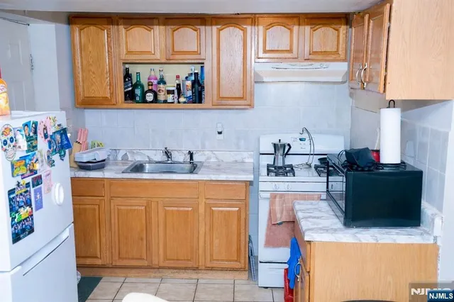 a kitchen with stainless steel appliances granite countertop a sink and a microwave
