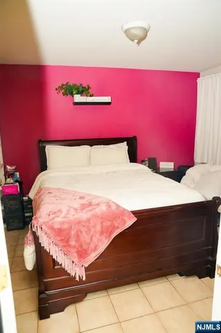 a bed with a pink blanket and pillows