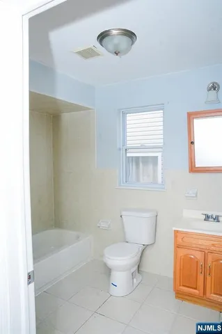 a bathroom with a toilet a sink and bathtub
