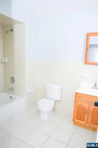 a bathroom with a toilet a sink a mirror and shower