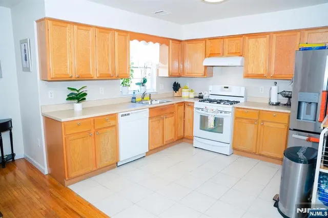 a kitchen with a stove top oven sink and cabinets