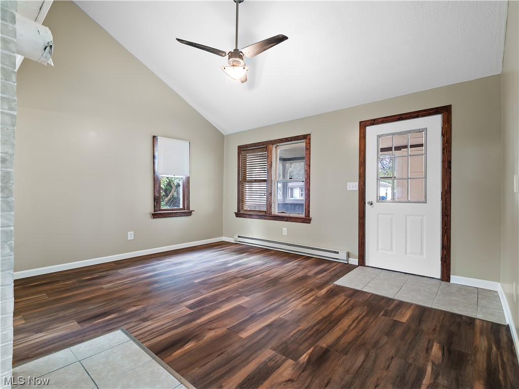 339 Cummings Road Vermilion, OH 44089 - Photo 19 of 35 Hardwood floored foyer entrance featuring ceiling fan, baseboard heating, plenty of natural light, and vaulted ceiling high