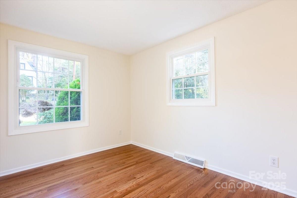 609 West Probart Street Brevard, NC 28712 - Photo 18 of 38 an empty room with wooden floor and windows