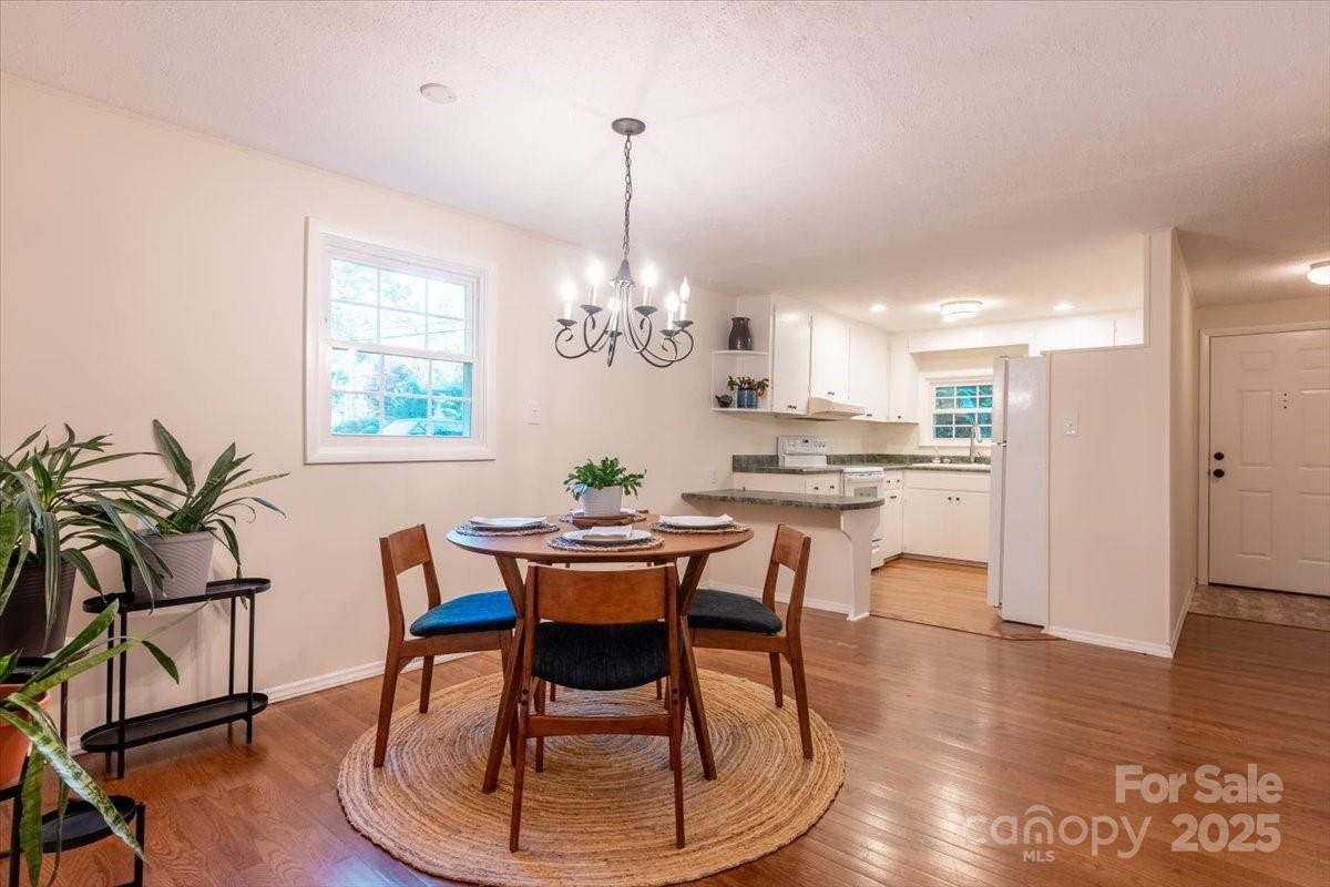 609 West Probart Street Brevard, NC 28712 - Photo 6 of 38 a dining room filled chandelier and wooden floor