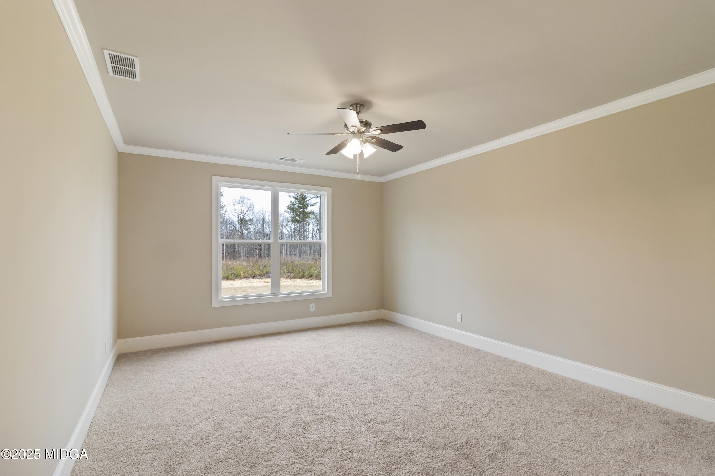 697 Giles Road Forsyth, GA 31029 - Photo 14 of 27 an empty room with a window and a ceiling fan
