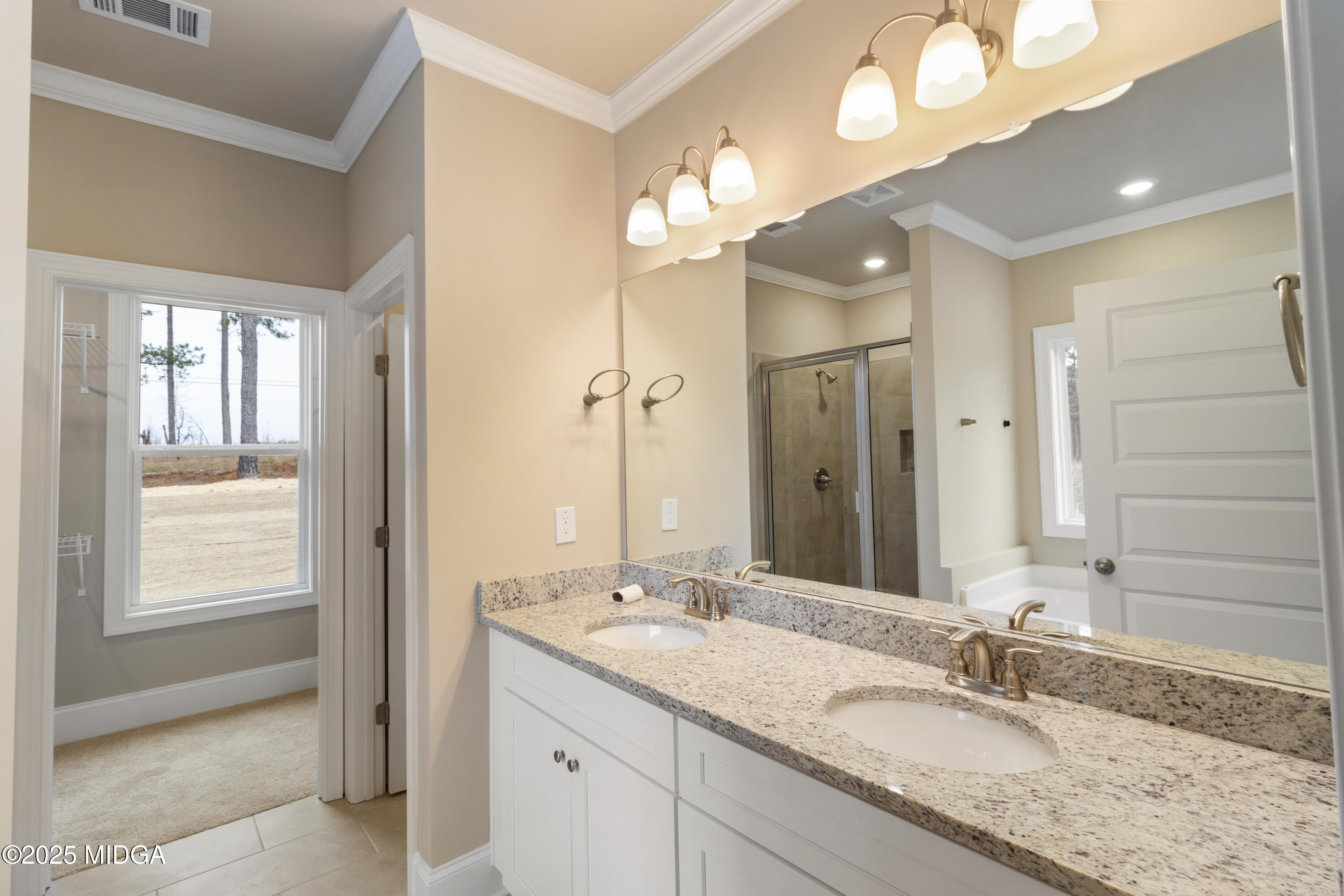 697 Giles Road Forsyth, GA 31029 - Photo 16 of 27 a bathroom with a granite countertop sink a light fixture and a mirror
