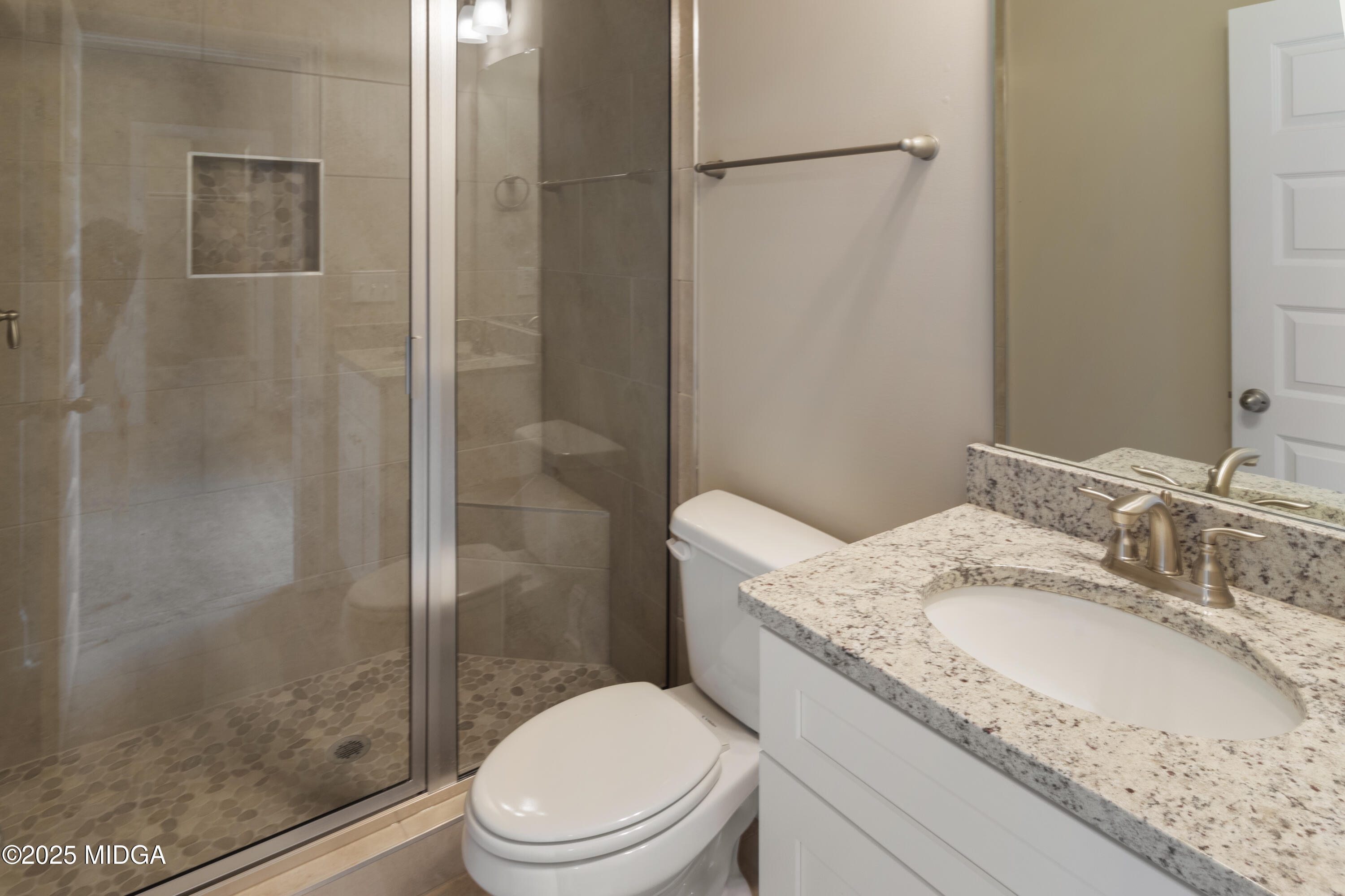 697 Giles Road Forsyth, GA 31029 - Photo 23 of 27 a bathroom with a granite countertop sink toilet and shower
