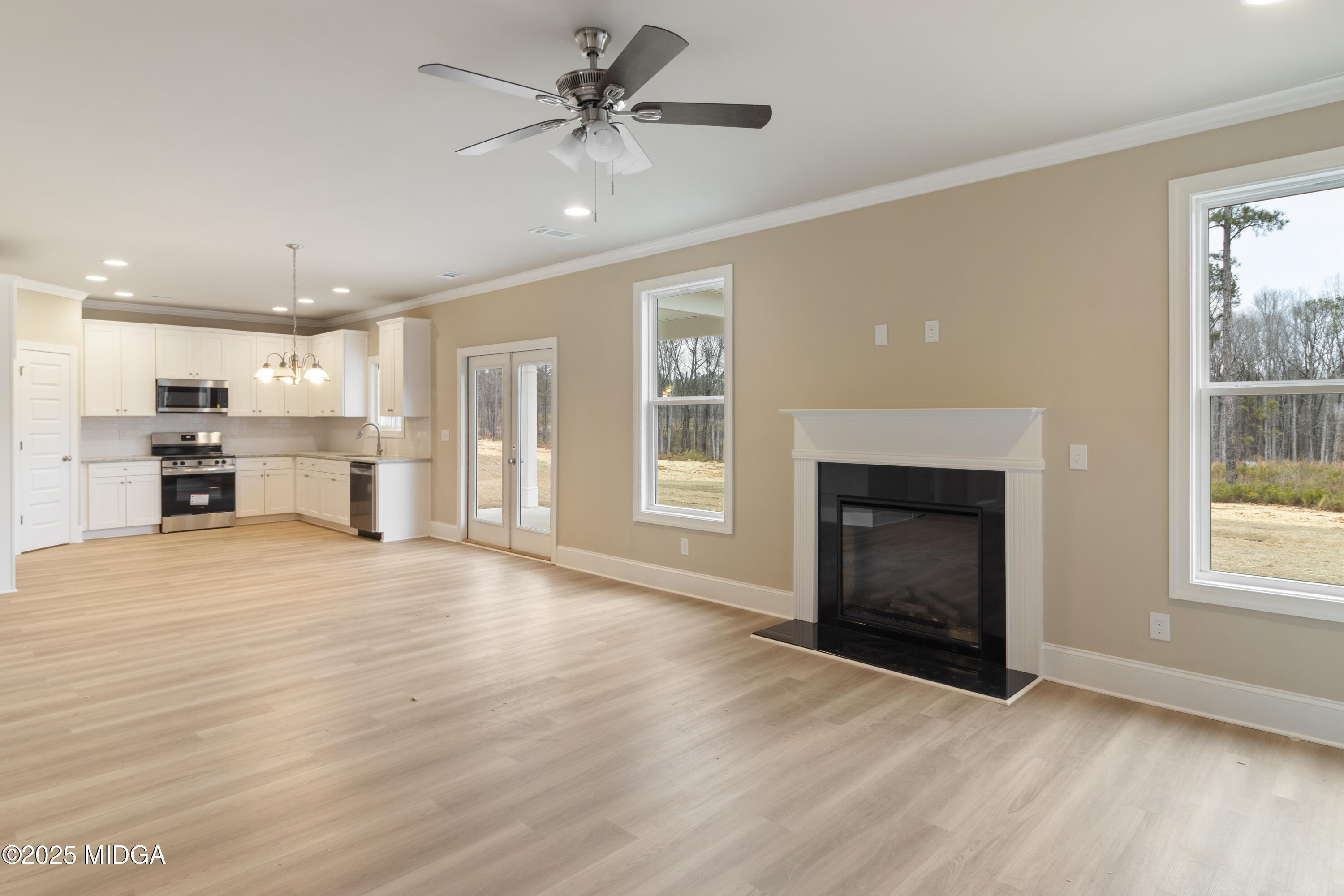 697 Giles Road Forsyth, GA 31029 - Photo 8 of 27 a view of an empty room with a window and fireplace