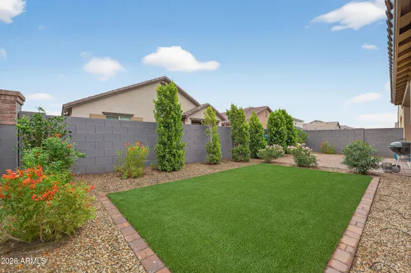 a front view of a house with a yard and potted plants