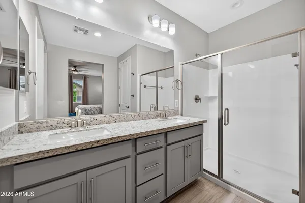 a bathroom with a granite countertop sink mirror and double