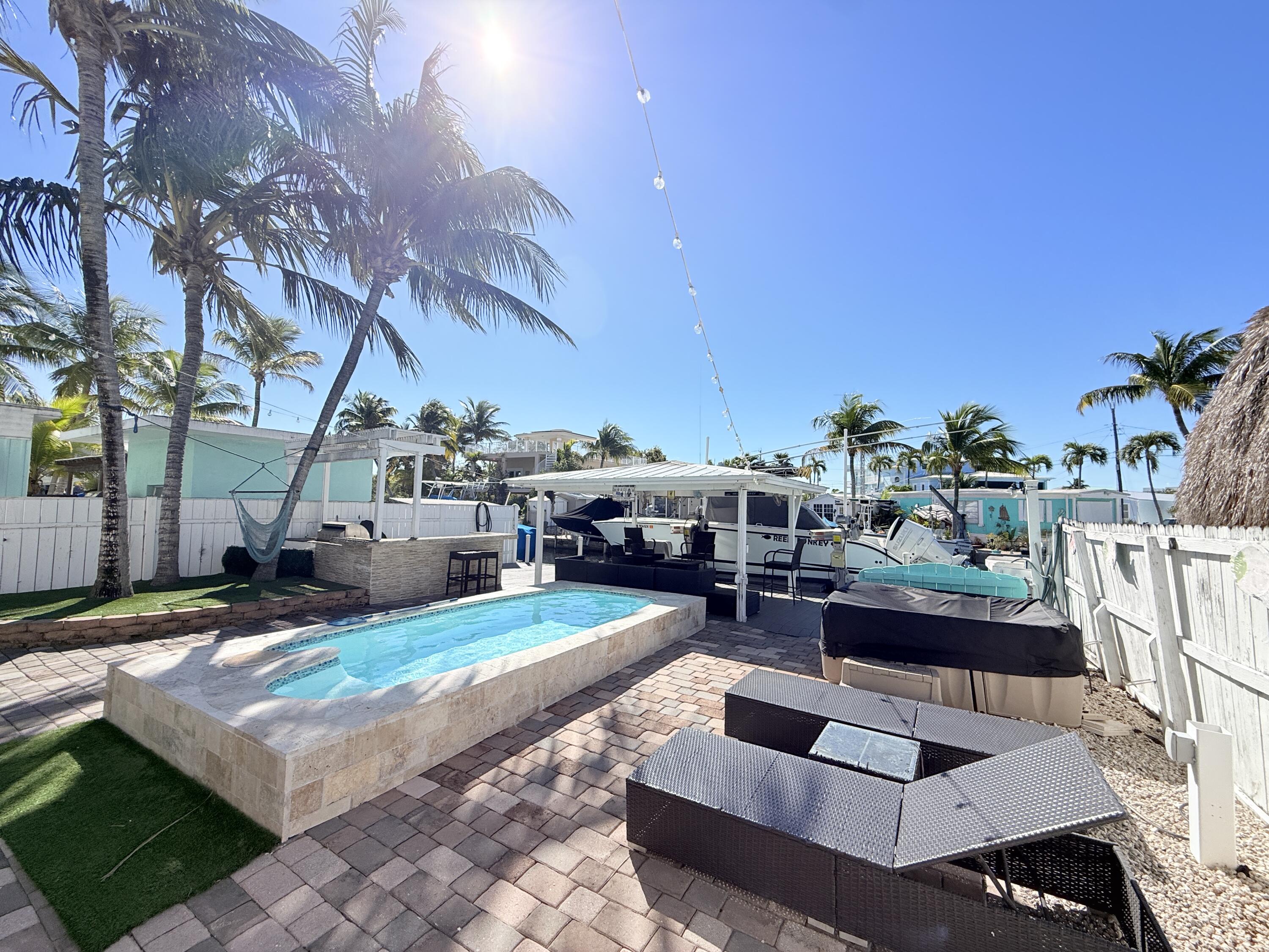 1313 Calder Road Key Largo, FL 33037 - Photo 4 of 72 Backyard pool, bbq and dock