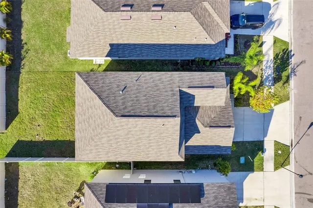 a aerial view of a house with table and chairs