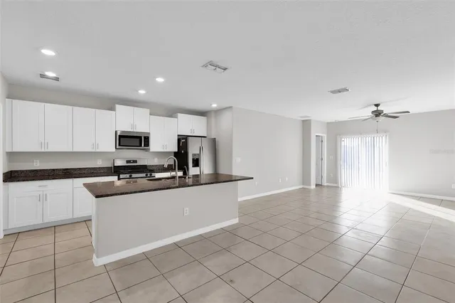 a kitchen with stainless steel appliances cabinets a sink and a stove