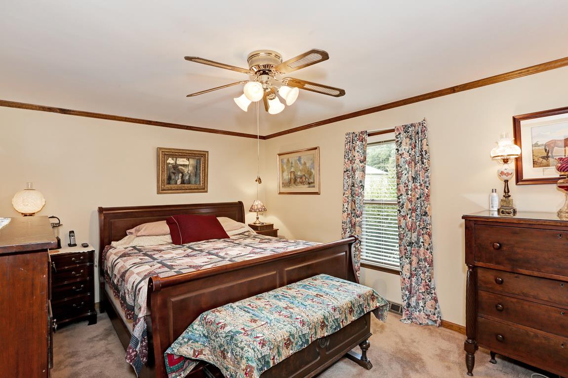 6536 Prospect Road Prospect, TN 38477 - Photo 12 of 30 a bedroom with a bed and a chandelier