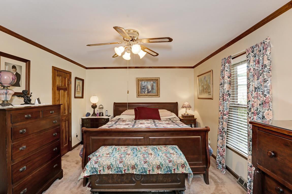 6536 Prospect Road Prospect, TN 38477 - Photo 13 of 30 a bedroom with a bed and wooden floor