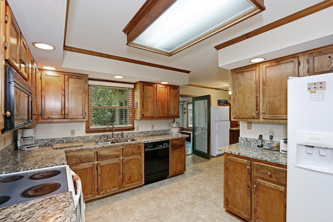 6536 Prospect Road Prospect, TN 38477 - Photo 7 of 30 a kitchen with stainless steel appliances granite countertop a sink stove and refrigerator