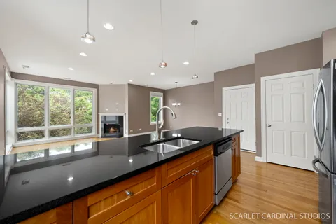 a kitchen with granite countertop sink and large window