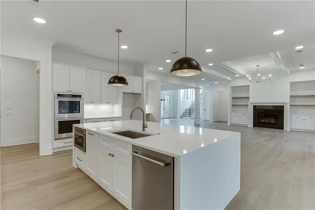 a view of an empty room with cabinet and mirrors