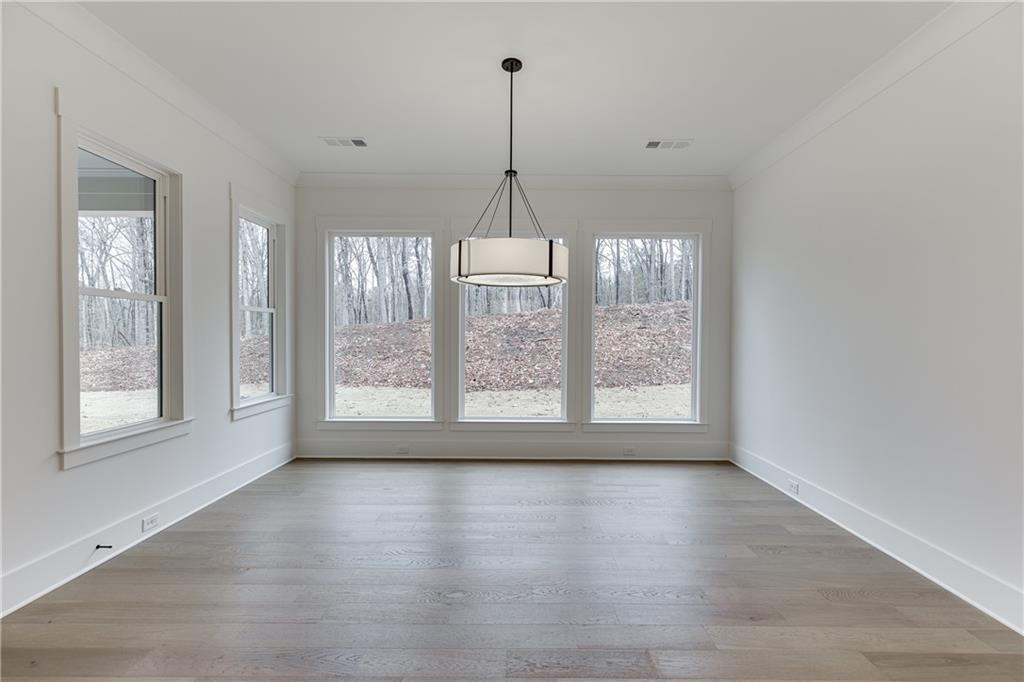 100 Gleneagles Way Pendergrass, GA 30567 - Photo 18 of 58 a view of an empty room with wooden floor and a window