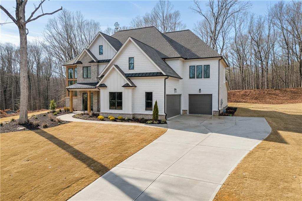 100 Gleneagles Way Pendergrass, GA 30567 - Photo 2 of 58 a front view of a house with yard and seating area