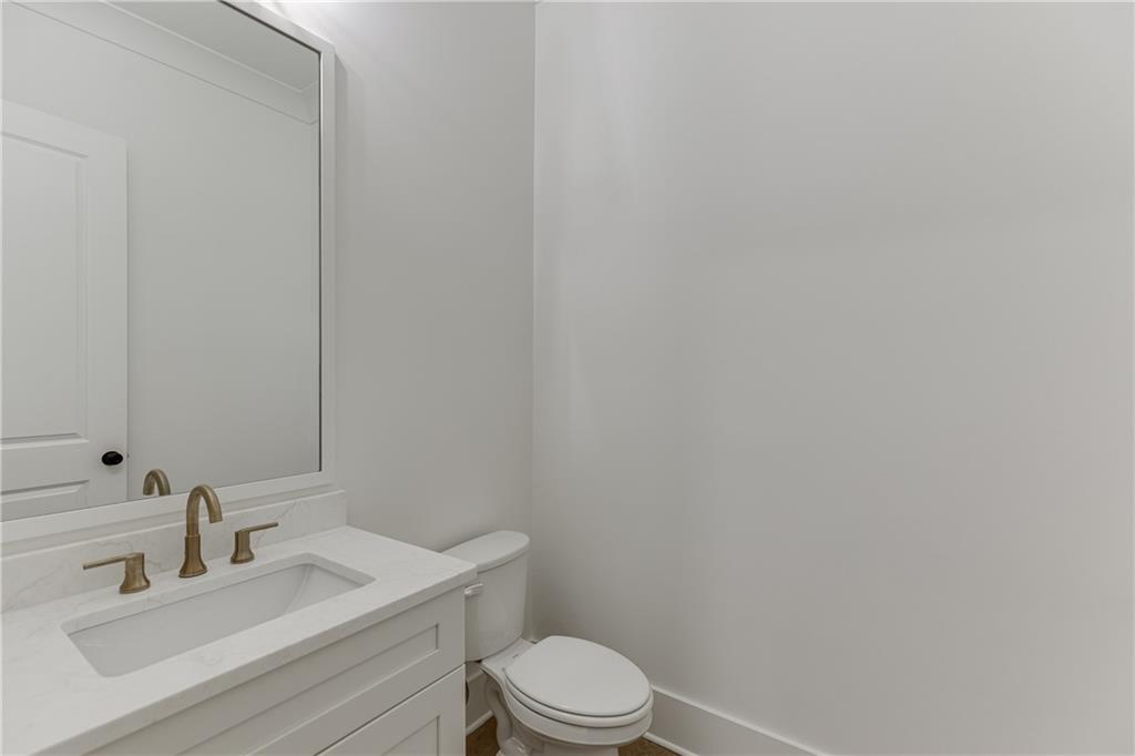 100 Gleneagles Way Pendergrass, GA 30567 - Photo 24 of 58 a bathroom with a sink toilet and mirror