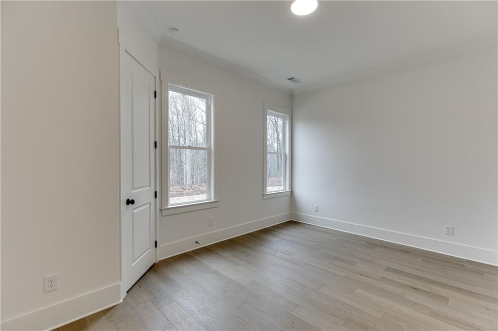 100 Gleneagles Way Pendergrass, GA 30567 - Photo 26 of 58 an empty room with wooden floor and windows