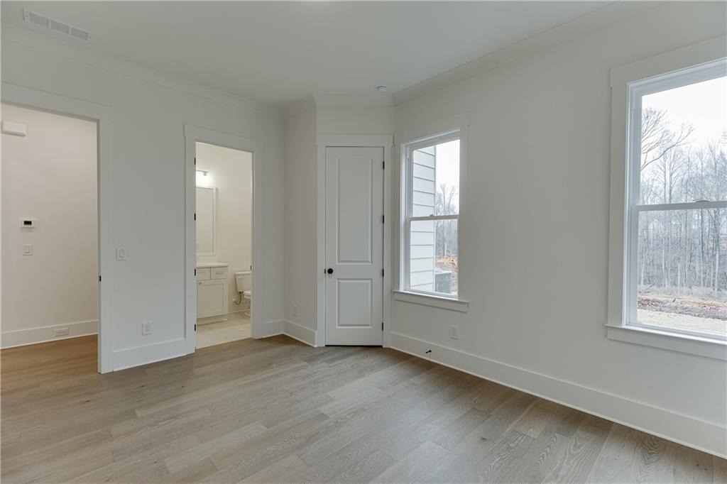 100 Gleneagles Way Pendergrass, GA 30567 - Photo 27 of 58 a view of an empty room with wooden floor and a window