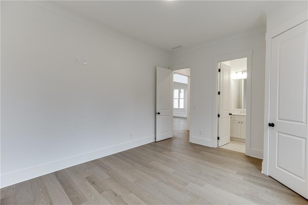 100 Gleneagles Way Pendergrass, GA 30567 - Photo 28 of 58 an empty room with wooden floor and mirror