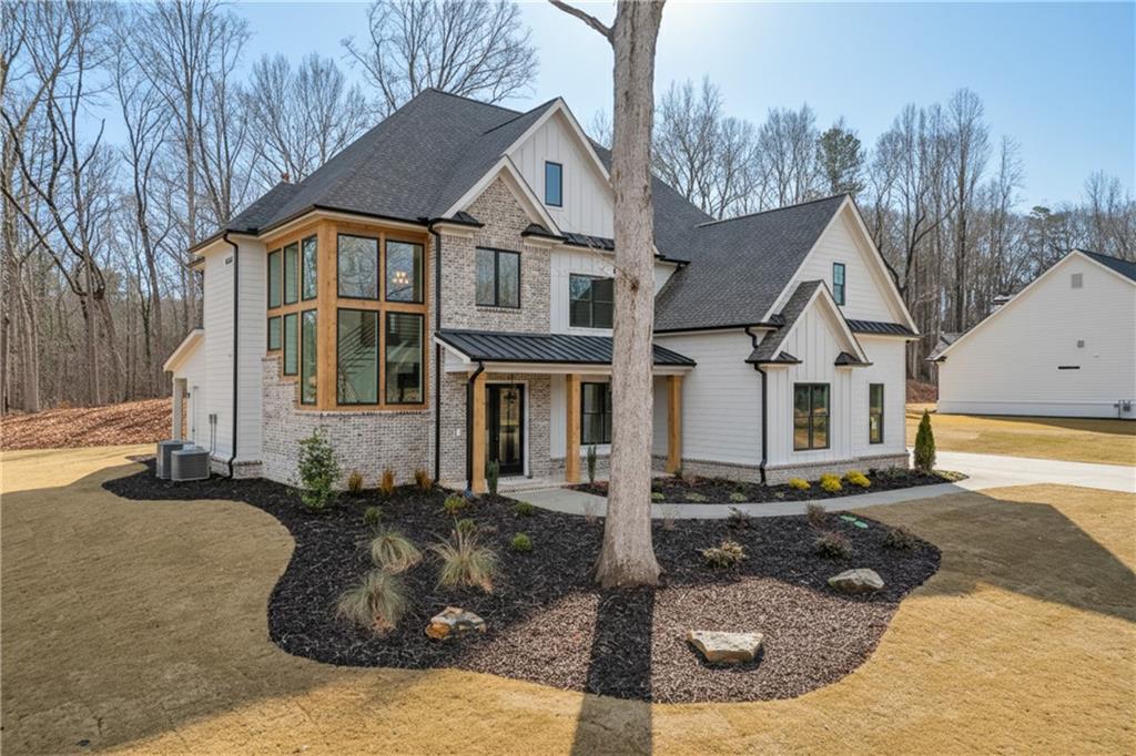 100 Gleneagles Way Pendergrass, GA 30567 - Photo 3 of 58 a front view of a house with a yard