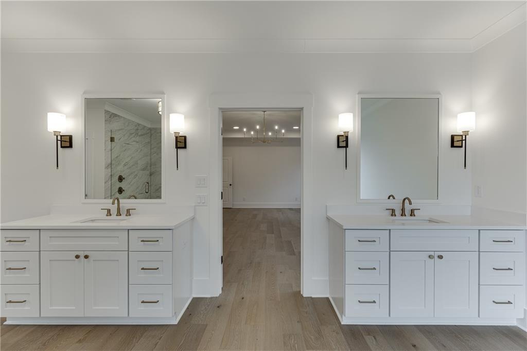 100 Gleneagles Way Pendergrass, GA 30567 - Photo 48 of 58 a bathroom with a double vanity sink and mirror